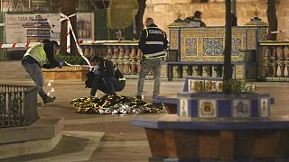 Spanish police cover the body of a catholic clergyman who was killed after being attacked with a machete.