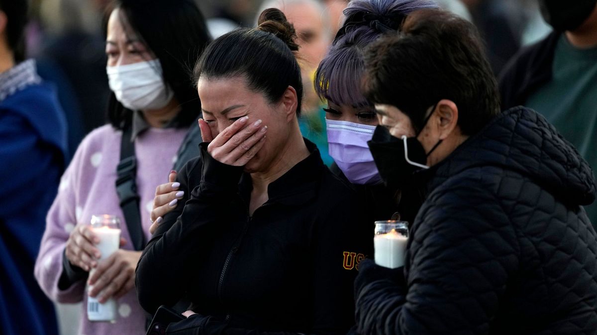 People attend a vigil outside Monterey Park City Hall, blocks from the Star Ballroom Dance Studio where a gunman killed multiple people celebrating the Lunar New Year