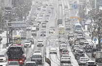 Vehicles drive in the snow in Suwon, South Korea, Thursday, Jan. 26, 2023.