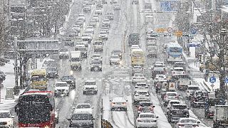 Vehicles drive in the snow in Suwon, South Korea, Thursday, Jan. 26, 2023.