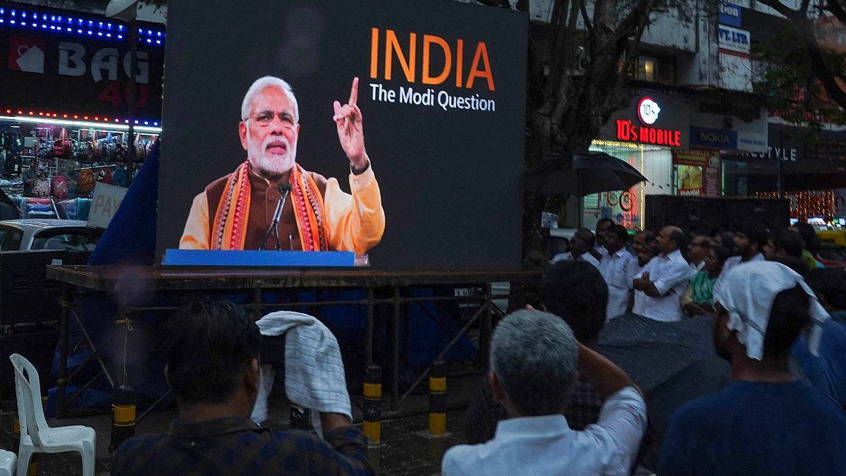 People watch the BBC documentary "India: The Modi Question", on an outdoor screen in Kochi on 24 January.