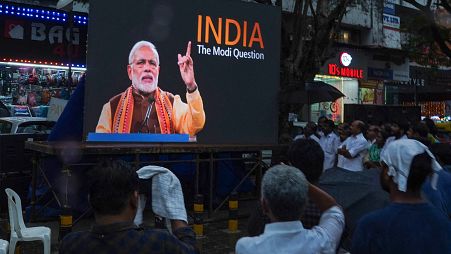 People watch the BBC documentary "India: The Modi Question", on an outdoor screen in Kochi on 24 January.
