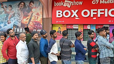 Fans lining up to watch "Pathaan" starring Shah Rukh Khan in Mumbai on 25 January.