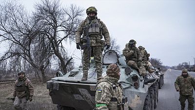 Ukrainian soldiers stand atop on APC before going to the frontline in Donetsk region, 28 January 2023