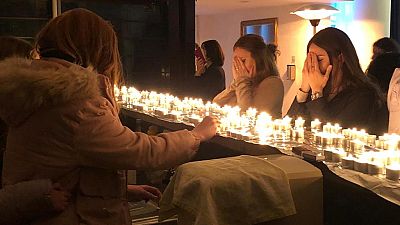 Jewish women gather to pray around candles.