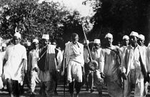 Mahatma Gandhi, with bared head and chest, leading his crusaders at the start of a march in the hope of changing salt laws during his civil disobedience campaign
