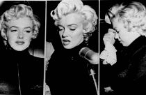 Tears well in the eyes of movie actress Marilyn Monroe as she faces reporters outside her home, October 6, 1954