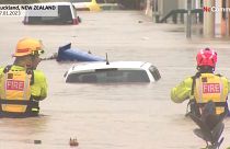 Firefighters try to reach stranded motorists in Auckland, New Zealand