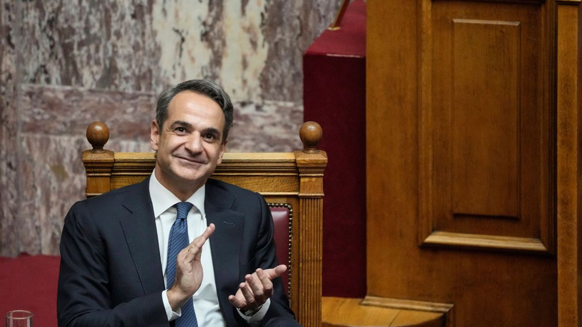 Greek Prime Minister Kyriakos Mitsotakis claps during a parliamentary debate on a motion of censure in Athens, on Friday, Jan. 27, 2023