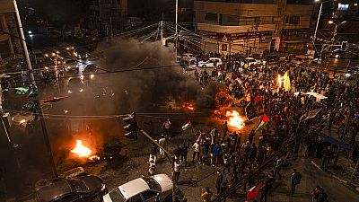 Palestinians celebrate after a shooting attack near a synagogue in Jerusalem, in Gaza City, Friday, Jan. 27, 2023. 