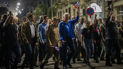 Cuba's President Miguel Diaz Canel, center right, and Raul Castro, center, take part in a march to mark the 167th anniversary of the birth of Cuba's national independence hero