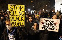 Demonstrators raise signs during a protest at Washington Square Park, Saturday, Jan. 28, 2023 in New York, in response to the death of Tyre Nichols