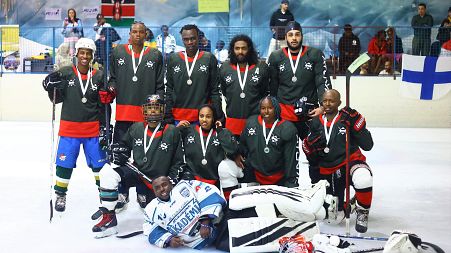 A group photo of The Kenya Ice Lions celebrating after taking part in a game
