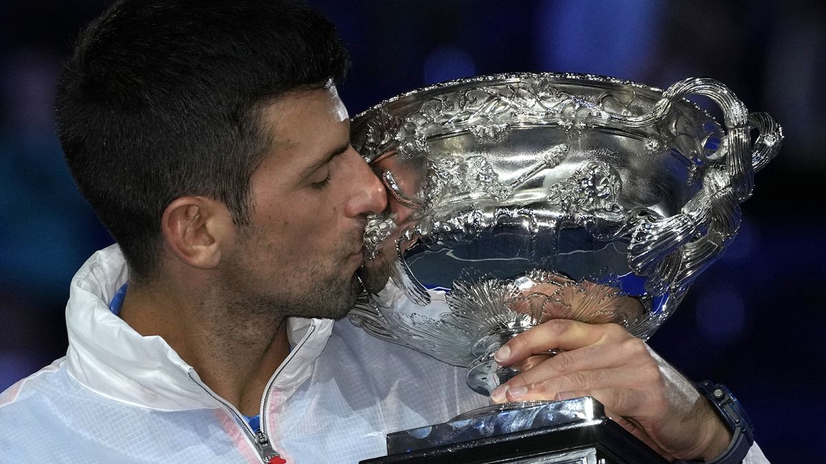Novak Djokovic of Serbia kisses the Norman Brookes Challenge Cup after winning in the men's singles final at the Australian Open in Melbourne, 29 January 2023