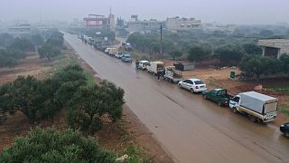 Vehicles backed up on a road in Syria