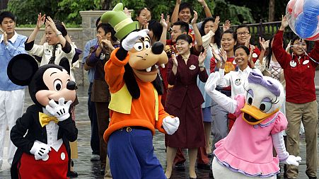 From left to right, Disney characters Mickey Mouse, Goofy and Daisy Duck at Hong Kong Disneyland.