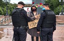 Russian police officers speak with climate activist Arshak Makichyan during a single-person demonstration in central Moscow, Russia in 2020.