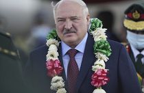 President Alexander Lukashenko of Belarus is presented with a garland of flowers upon landing in Zimbabwe.