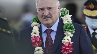 President Alexander Lukashenko of Belarus is presented with a garland of flowers upon landing in Zimbabwe.