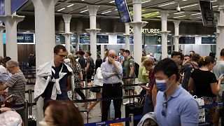 People queue to check in for the Eurostar rail service at St Pancras International Station in London, Britain, July 25, 2022.