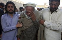 People mourn over the death of their relative, a police officer killed in the Monday's suicide bombing inside a mosque in Peshawar, Pakistan, Tuesday, Jan. 31, 2023.