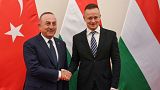 Hungarian Minister of Foreign Affairs and Trade Peter Szijjarto, right, receives Foreign Minister of Turkey Mevlut Cavusoglu for talks in his office in Budapest, Hungary, Tues