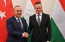 Hungarian Minister of Foreign Affairs and Trade Peter Szijjarto, right, receives Foreign Minister of Turkey Mevlut Cavusoglu for talks in his office in Budapest, Hungary, Tues