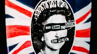 A promotional poster for the 1977 single God Save The Queen by the Sex Pistols on display.