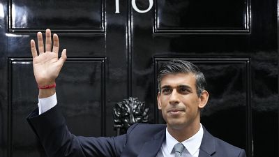 British Prime Minister Rishi Sunak waves after arriving at Downing Street in London