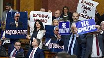 Serbian Lawmakers hold pictures of assassinated Kosovo Serb politician Oliver Ivanovic and banners that read: "Not to the ultimatum!" and "Vucic, betrayed Kosovo". 