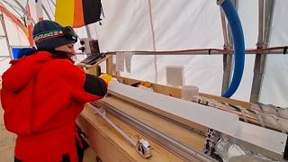 A researcher for the 'Beyond Epica' project polishes an ice sample. 