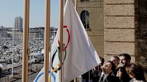 The Mayor of Marseille Benoit Payan, raises the Olympic flag with the Head of the Paris 2024 Olympics, Tony Estanguet, after a press conference at Marseille City Hall.