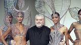 Franco-Spanish fashion designer Paco Rabanne embraces models after the presentation of his spring - summer collection on January 27, 1993 in Paris, France. 