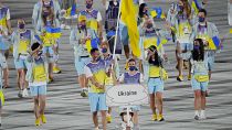 Olena Kostevych and Bogdan Nikishin carry Ukraine's flag during the opening ceremony in the Olympic Stadium at the 2020 Summer Olympics in 2021.