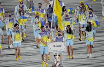 Olena Kostevych and Bogdan Nikishin carry Ukraine's flag during the opening ceremony in the Olympic Stadium at the 2020 Summer Olympics in 2021.