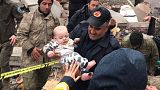 A baby is rescued from a destroyed building in Malatya, Turkey, Monday, Feb. 6, 2023. A powerful quake has knocked down multiple buildings in southeast Turkey and Syria and ma