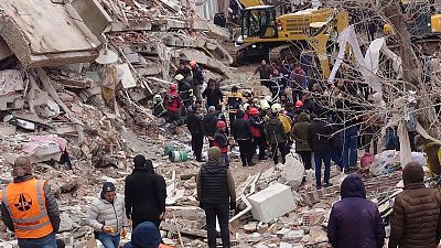 Rescue workers search for survivors under the rubble of a collapsed building in Diyarbakir, southeastern Turkey, Monday, Feb. 6, 2023. 