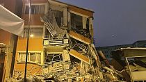 A collapsed building is seen following an earthquake in Pazarcik, in Kahramanmaras province, southern Turkey, early Monday, Feb. 6, 2023.