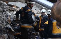 Members of the Syrian civil defence, known as the White Helmets, searching through the rubble of collapsed buildings in the town of Sarmada, after an earthquake hit the region