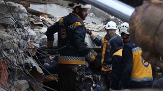 Members of the Syrian civil defence, known as the White Helmets, searching through the rubble of collapsed buildings in the town of Sarmada, after an earthquake hit the region