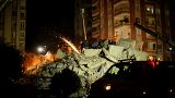 Emergency team members search for people in a destroyed building in Adana, Turkey on Tuesday evening.