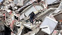 Habitante desce pelos escombros de um prédio, em Kahramanmaras, na Turquia