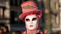 A woman wears a mask in St. Mark's Square during the Venice Carnival.