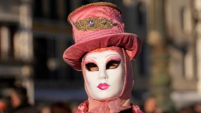 A woman wears a mask in St. Mark's Square during the Venice Carnival.