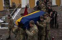 Soldiers carry the coffin of Eduard Strauss, a Ukrainian serviceman who died in combat on Jan. 17 in Bakhmut, during a farewell ceremony in Kyiv, Ukraine, Monday, Feb. 6, 2023