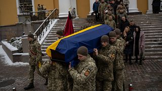 Soldiers carry the coffin of Eduard Strauss, a Ukrainian serviceman who died in combat on Jan. 17 in Bakhmut, during a farewell ceremony in Kyiv, Ukraine, Monday, Feb. 6, 2023