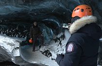 Tourist group visits The Black Diamond cave in Breiðamerkurjökull, southeast Iceland.