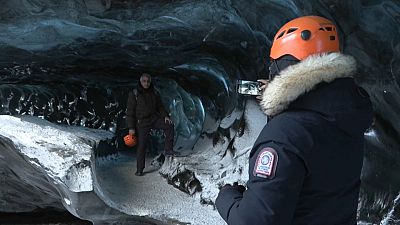 Tourist group visits The Black Diamond cave in Breiðamerkurjökull, southeast Iceland.