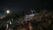 Emergency workers and medics rescue a woman out of the debris of a collapsed building in Elbistan, Kahramanmaras, in southern Turkey.
