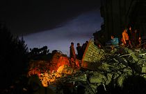 Emergency team members search for people in a destroyed building in Adana, Turkey, Tuesday, Feb. 7, 2023.